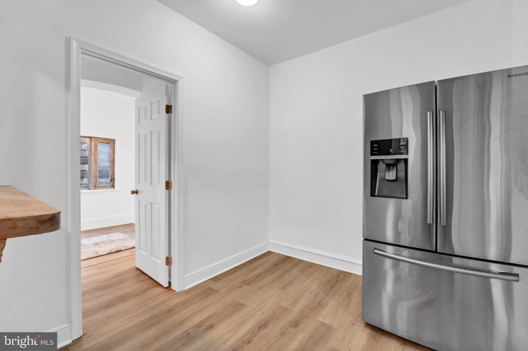 2219 Chesterfield Avenue Baltimore, MD 21213 - Photo 11 of 30 Modern kitchen with sleek stainless steel fridge.