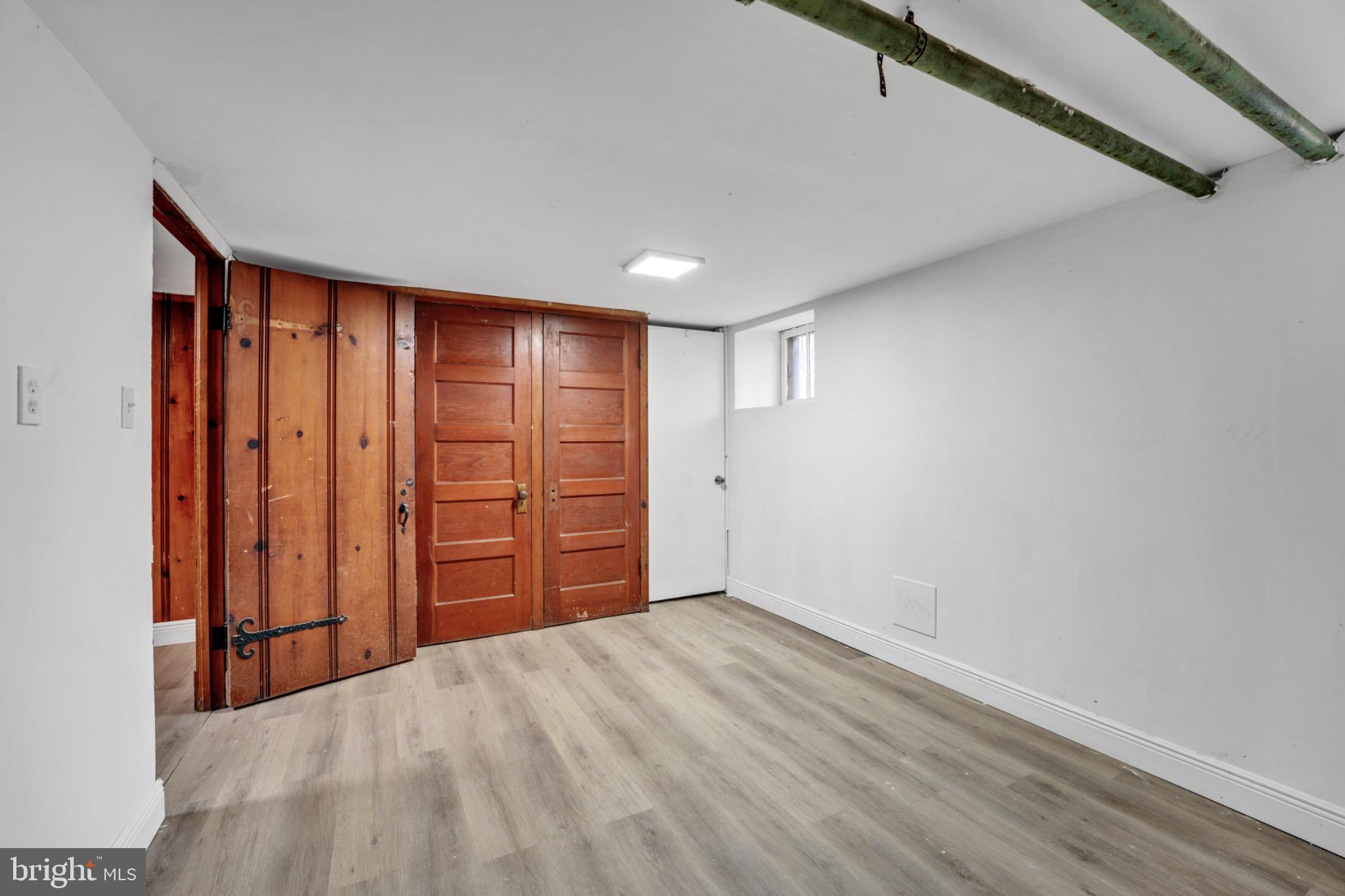 2219 Chesterfield Avenue Baltimore, MD 21213 - Photo 24 of 30 Spacious basement with rustic wooden doors.
