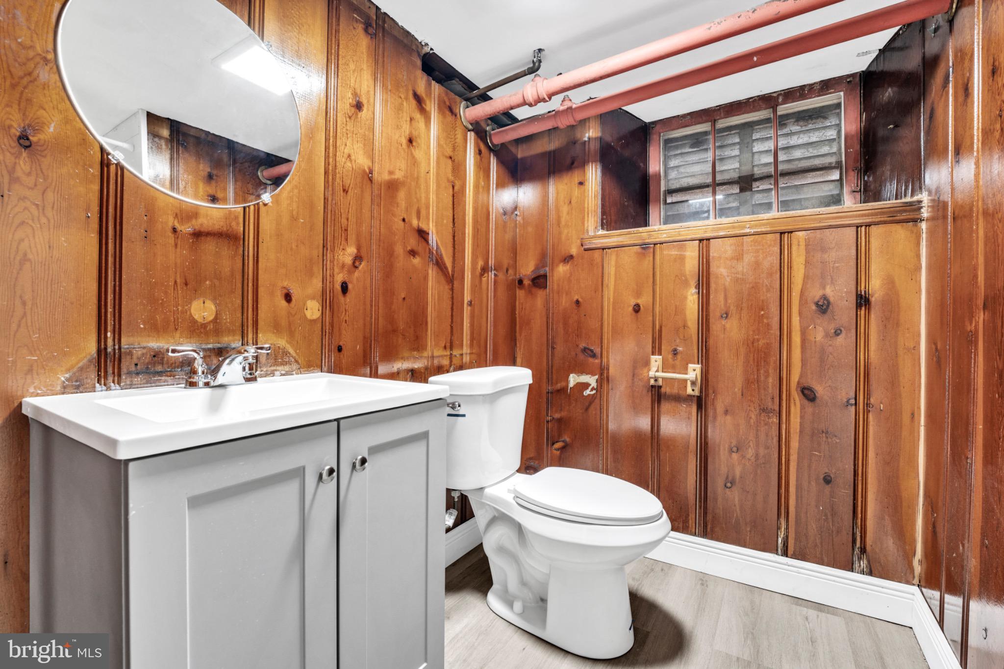 2219 Chesterfield Avenue Baltimore, MD 21213 - Photo 27 of 30 Cozy bathroom with rustic wooden walls.