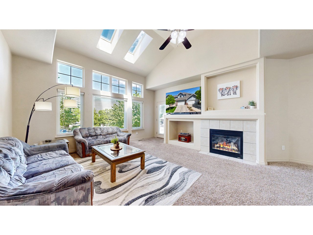 4672 West 20th Road, Unit 413 Greeley, CO 80634 - Photo 2 of 37 a living room with furniture and a fireplace