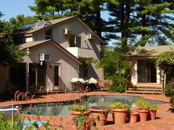 425 Taylor Road Stow, MA 01775 - Photo 23 of 28 a front view of a house with swimming pool and chairs