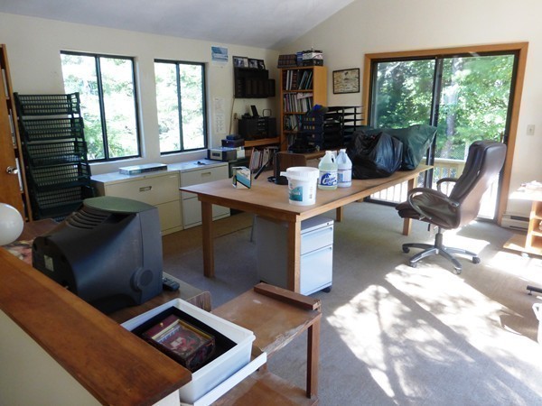425 Taylor Road Stow, MA 01775 - Photo 26 of 28 a living room with furniture floor to ceiling window and a flat screen tv