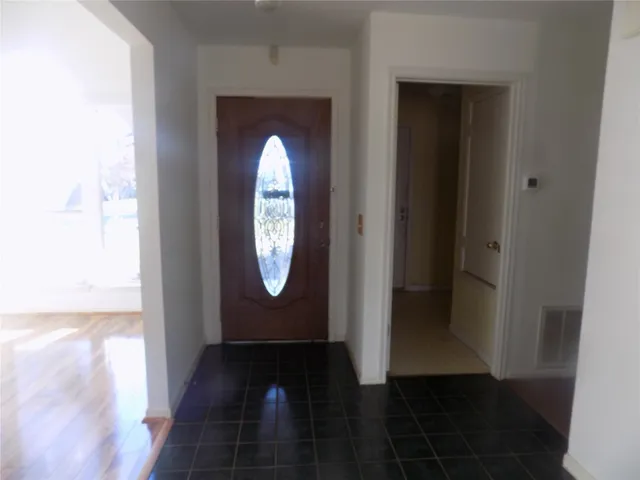 a view of a door with wooden floor