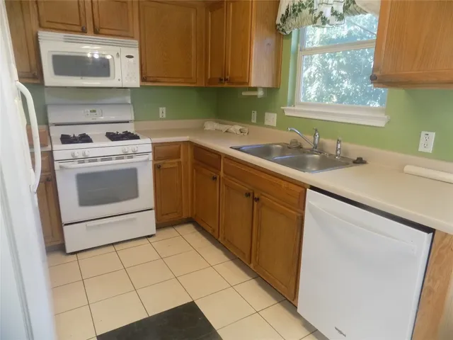 a kitchen with a sink cabinets and window