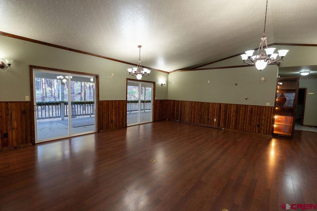 19 Pine Cone Circle Bayfield, CO 81122 - Photo 12 of 31 an empty room with wooden floor and windows
