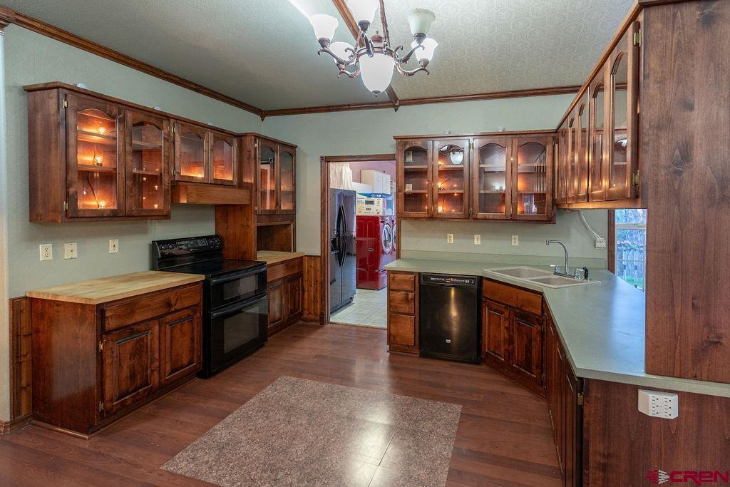 19 Pine Cone Circle Bayfield, CO 81122 - Photo 7 of 31 a kitchen with stainless steel appliances granite countertop wooden cabinets a stove top oven a sink and dishwasher