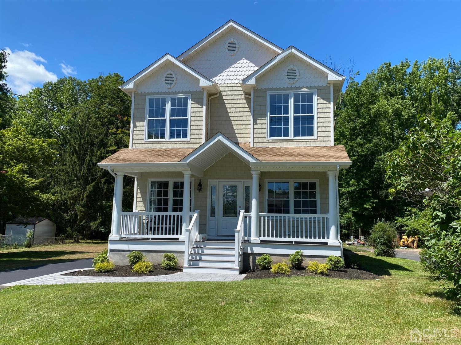 99 Jordan Road Colonia, NJ 07067 - Photo 1 of 53 a front view of a house with a garden and yard