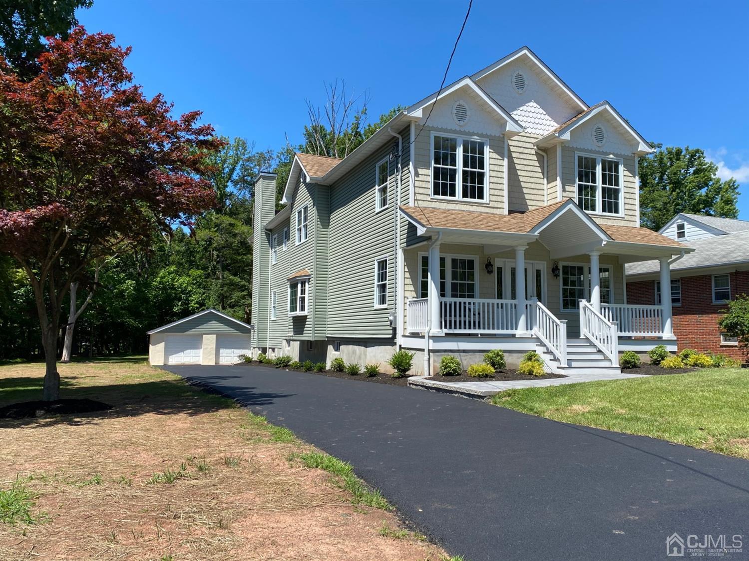 99 Jordan Road Colonia, NJ 07067 - Photo 2 of 53 a front view of a house with a yard table and chairs