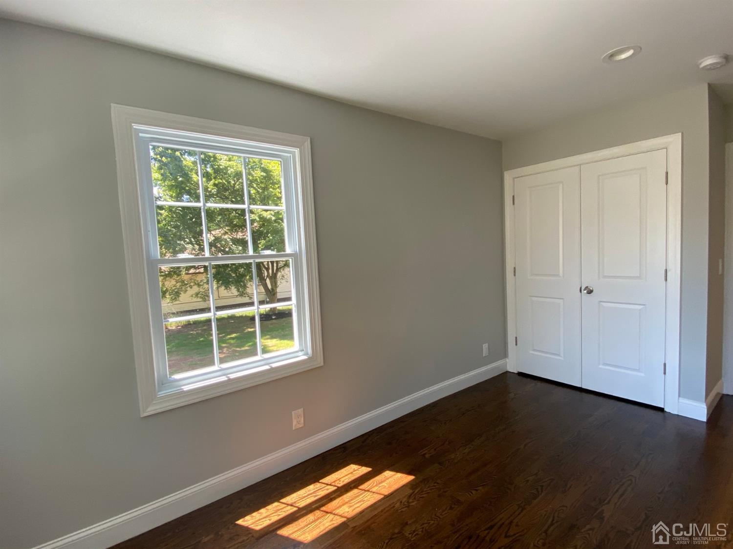 99 Jordan Road Colonia, NJ 07067 - Photo 11 of 53 an empty room with wooden floor and windows