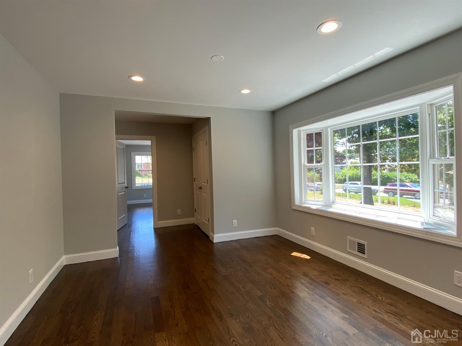 99 Jordan Road Colonia, NJ 07067 - Photo 14 of 53 a view of an empty room with wooden floor and a window