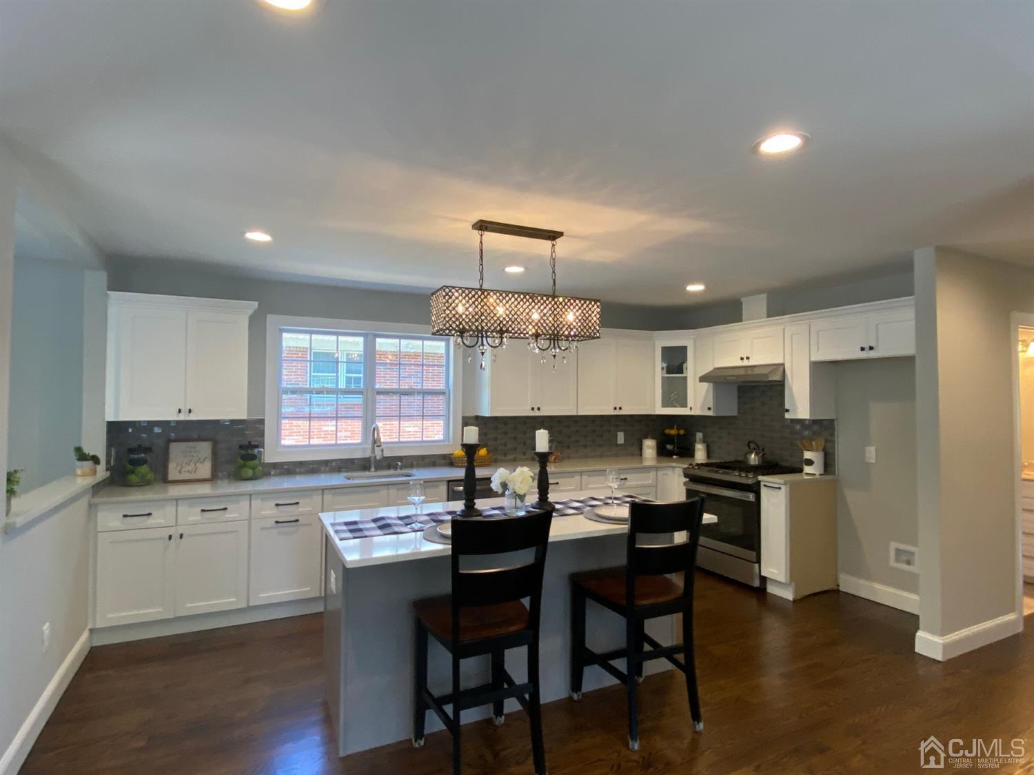 99 Jordan Road Colonia, NJ 07067 - Photo 19 of 53 a kitchen with a dining table chairs and refrigerator