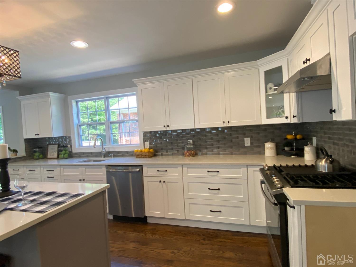 99 Jordan Road Colonia, NJ 07067 - Photo 22 of 53 a kitchen with granite countertop white cabinets and white appliances
