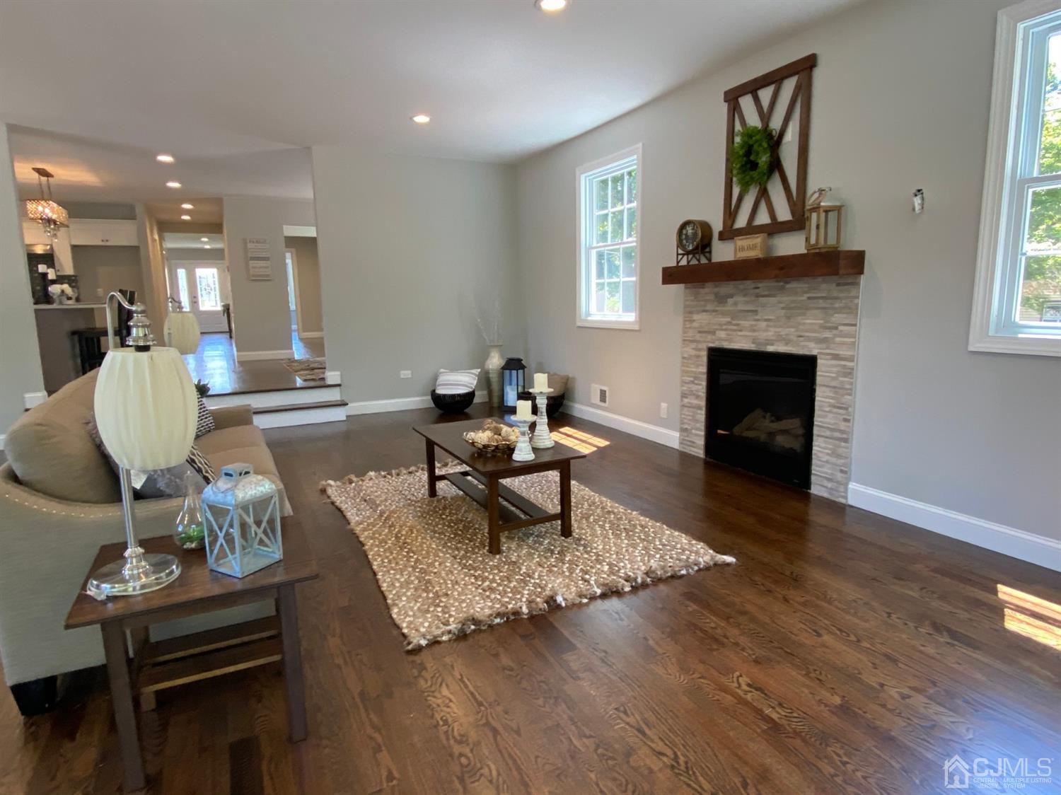 99 Jordan Road Colonia, NJ 07067 - Photo 29 of 53 a living room with furniture a fireplace and a table