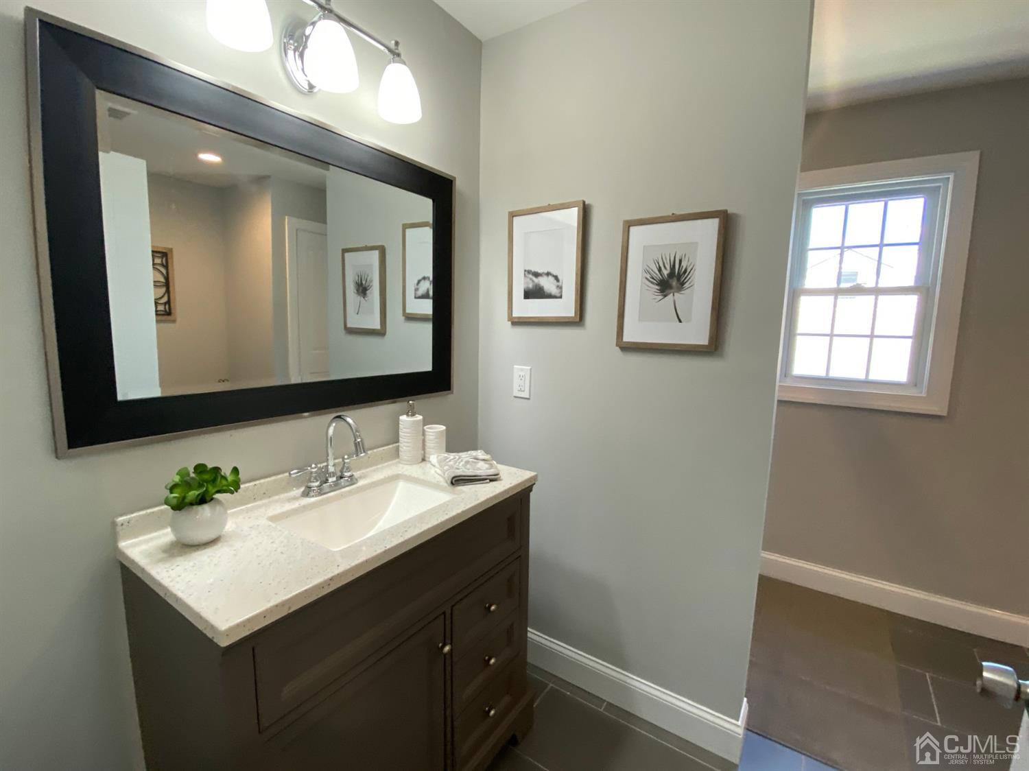 99 Jordan Road Colonia, NJ 07067 - Photo 45 of 53 a bathroom with a sink and a mirror
