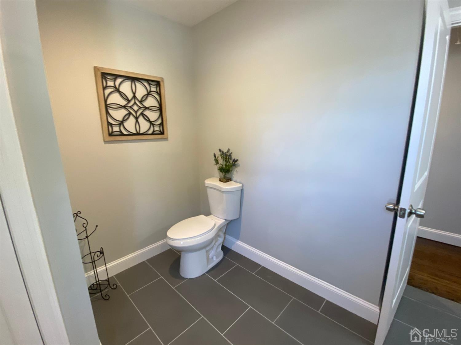 99 Jordan Road Colonia, NJ 07067 - Photo 46 of 53 a white toilet sitting next to a white sink and vanity