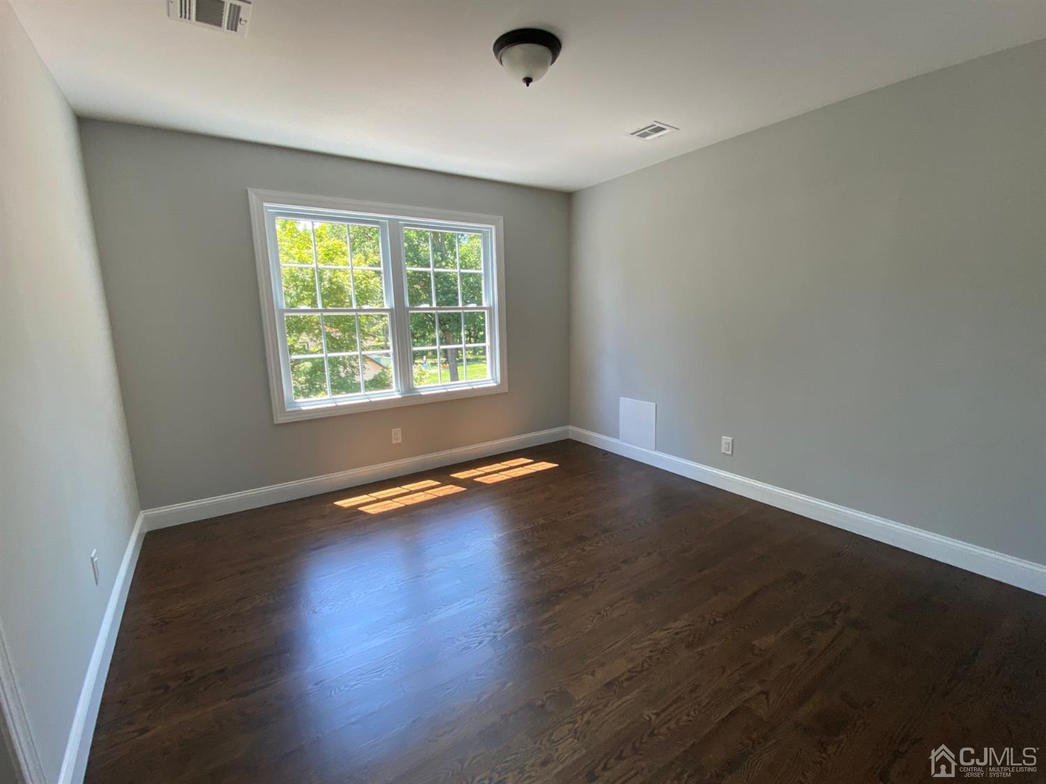 99 Jordan Road Colonia, NJ 07067 - Photo 48 of 53 an empty room with wooden floor and windows