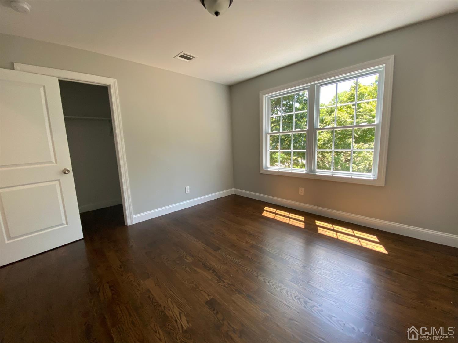 99 Jordan Road Colonia, NJ 07067 - Photo 49 of 53 a view of an empty room with wooden floor and a window
