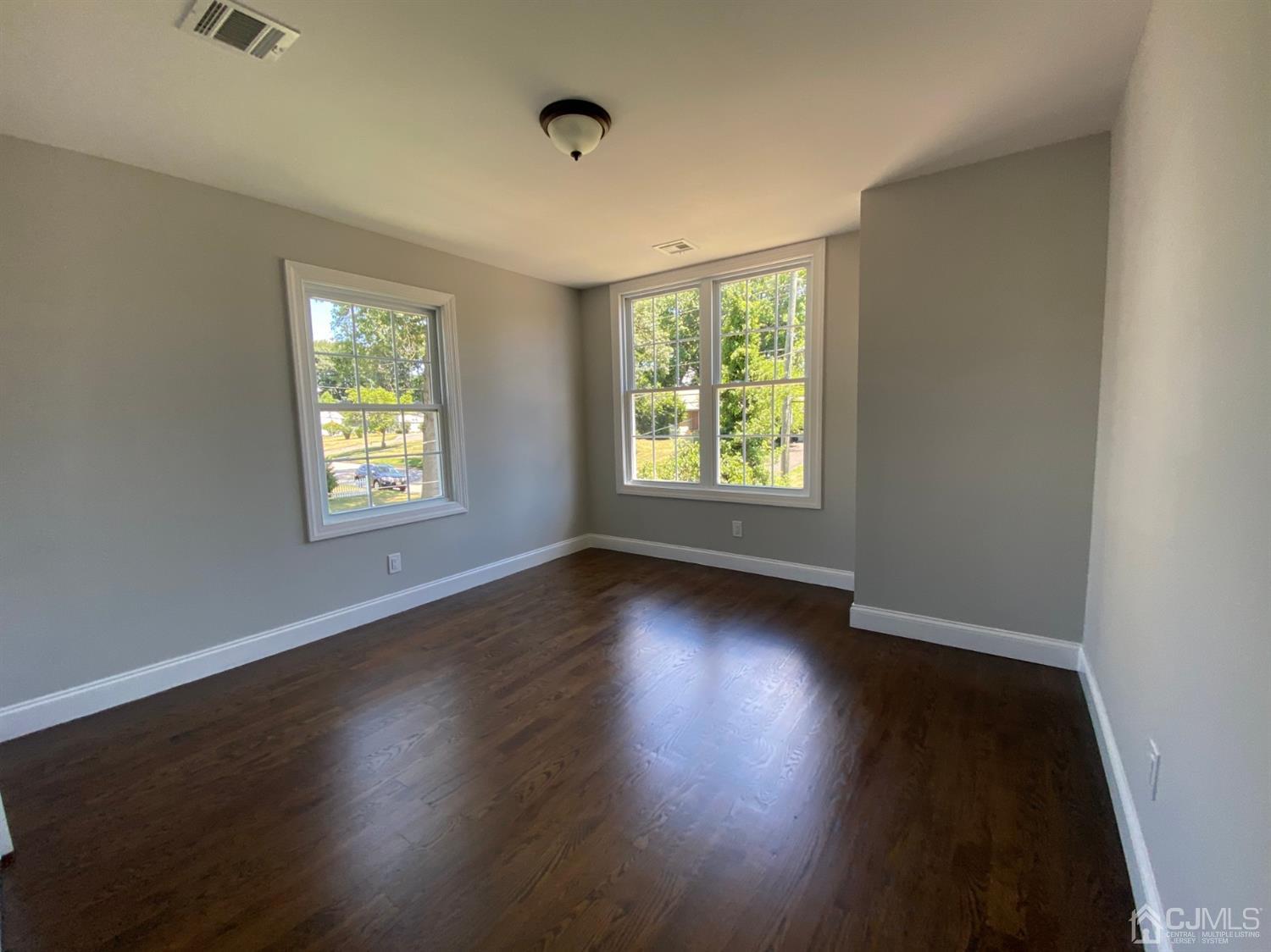 99 Jordan Road Colonia, NJ 07067 - Photo 50 of 53 an empty room with wooden floor and windows