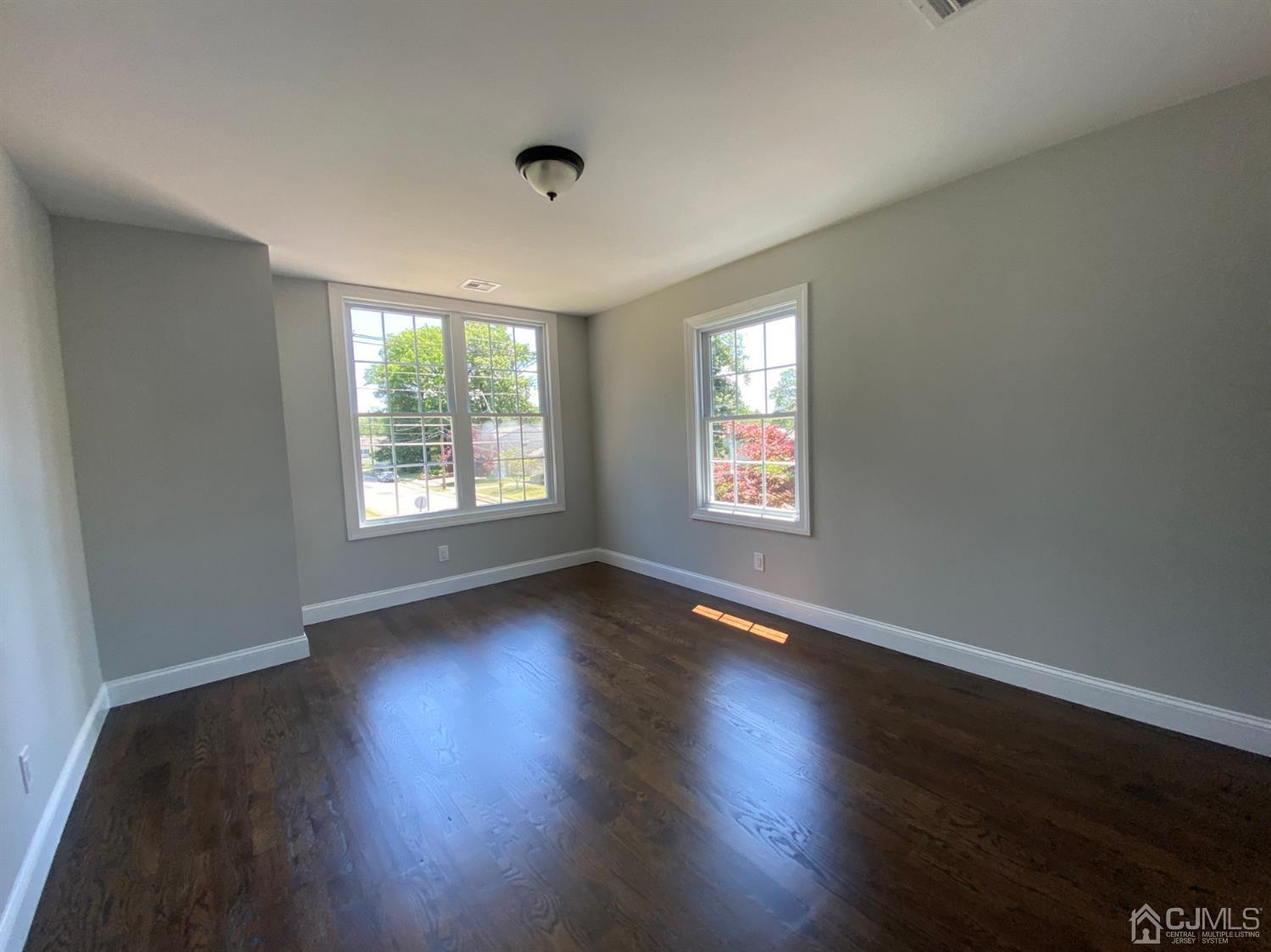99 Jordan Road Colonia, NJ 07067 - Photo 51 of 53 an empty room with wooden floor and windows