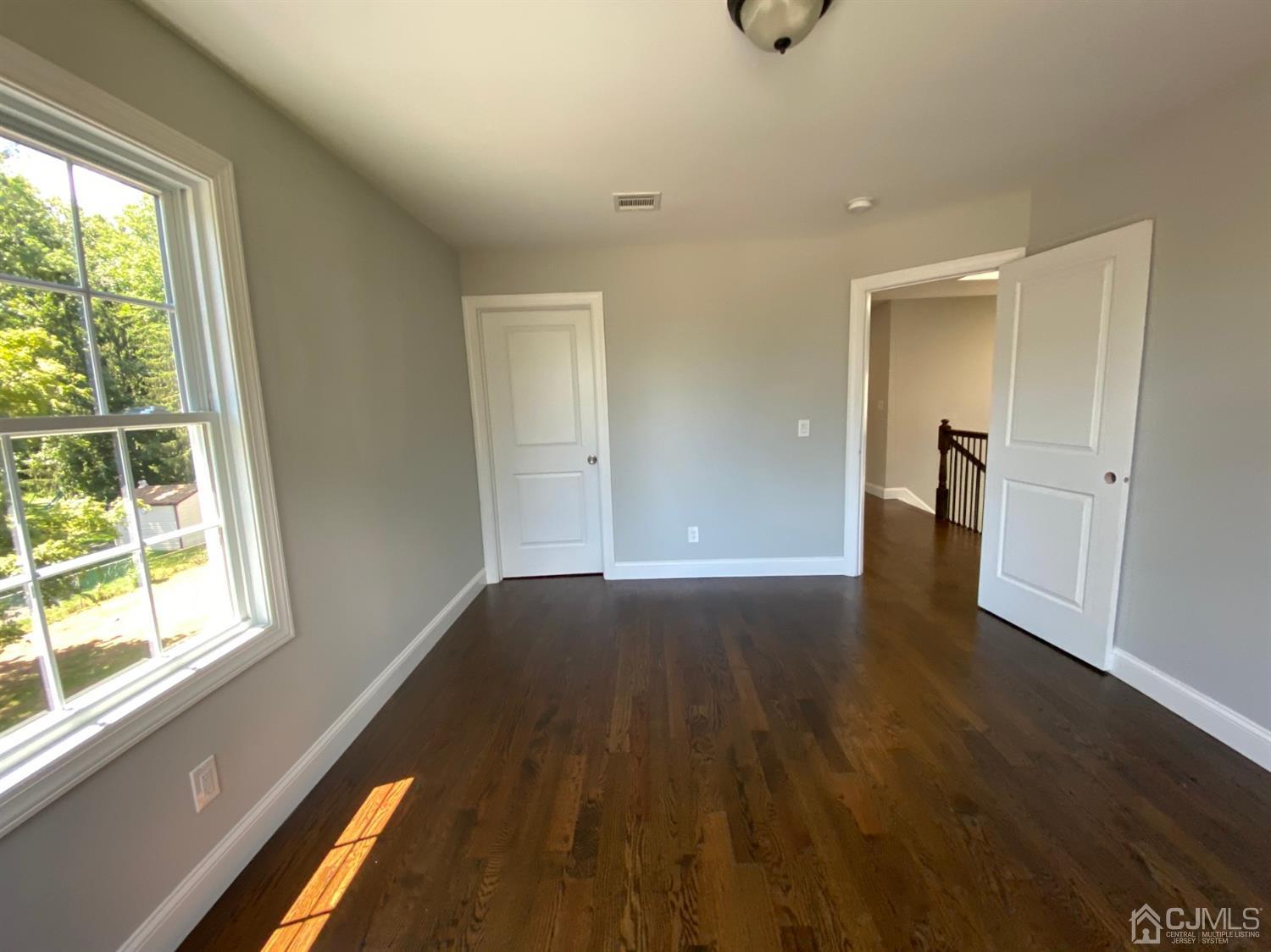 99 Jordan Road Colonia, NJ 07067 - Photo 53 of 53 a view of an empty room with wooden floor and a window