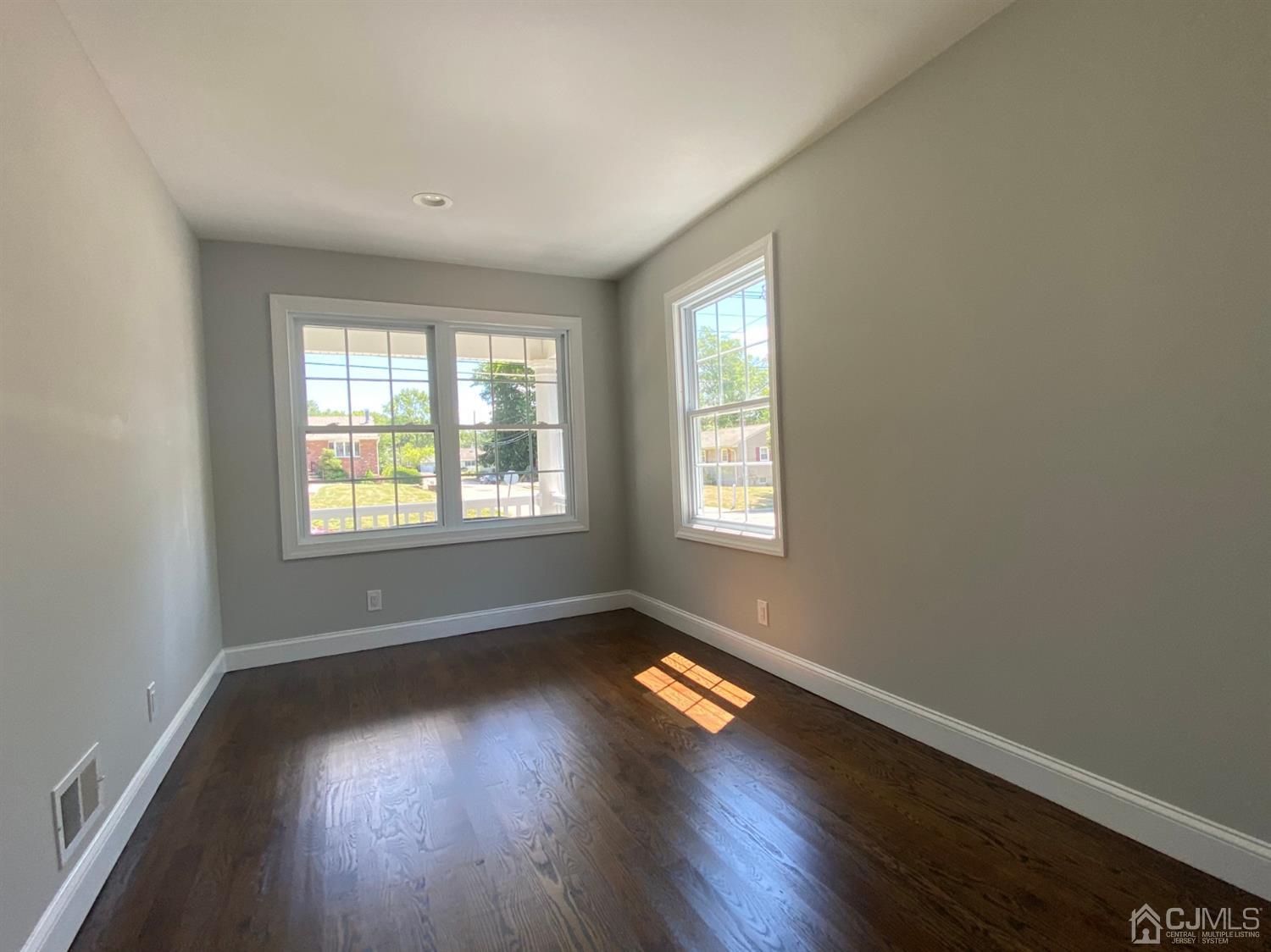 99 Jordan Road Colonia, NJ 07067 - Photo 9 of 53 an empty room with wooden floor and windows