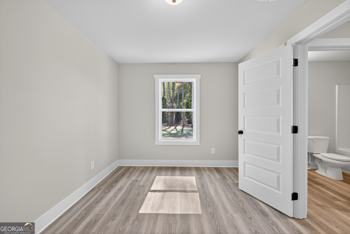 271 Mockingbird Lane, Unit 20 Winder, GA 30680 - Photo 17 of 38 a view of empty room with wooden floor and fan