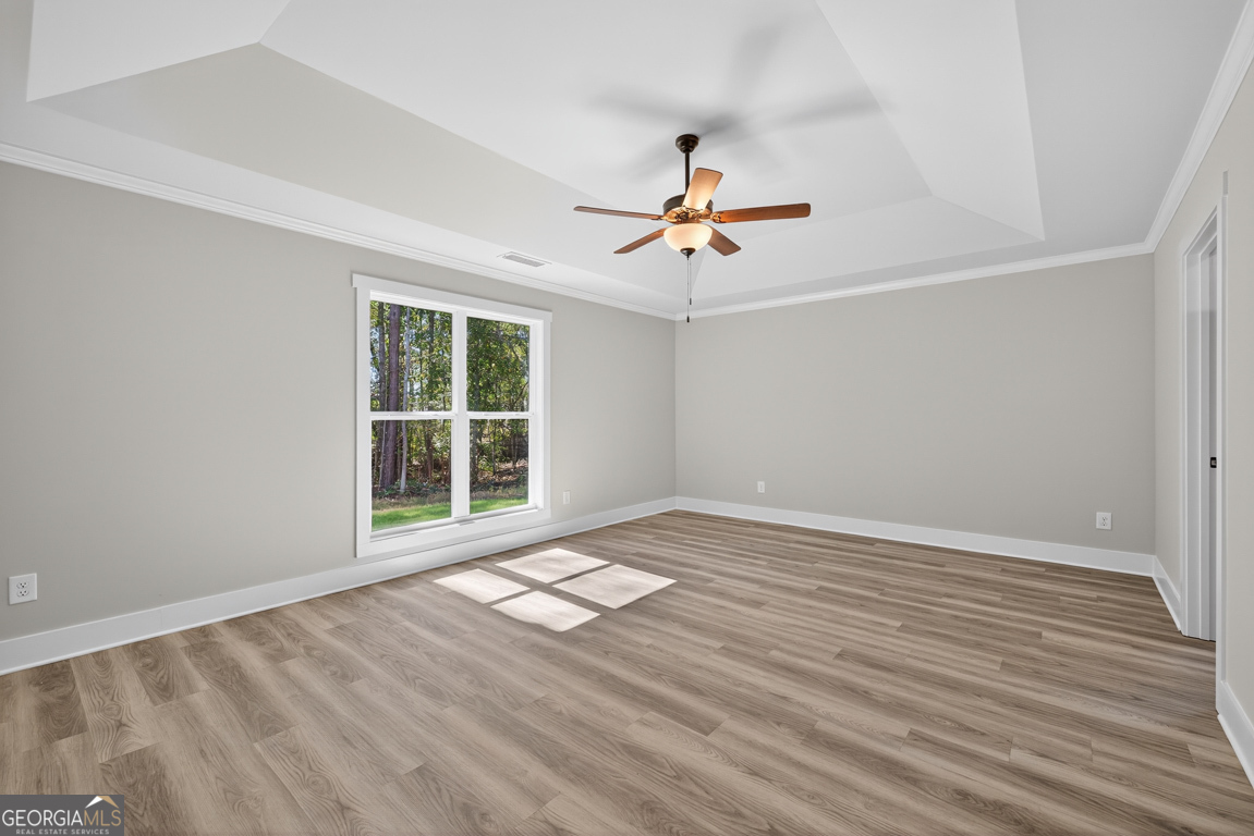 271 Mockingbird Lane, Unit 20 Winder, GA 30680 - Photo 26 of 38 a view of an empty room with a window and wooden floor