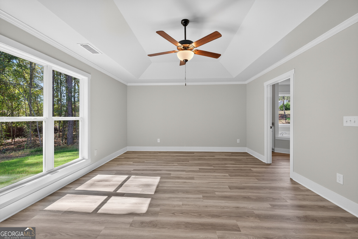 271 Mockingbird Lane, Unit 20 Winder, GA 30680 - Photo 27 of 38 a view of empty room with wooden floor and fan