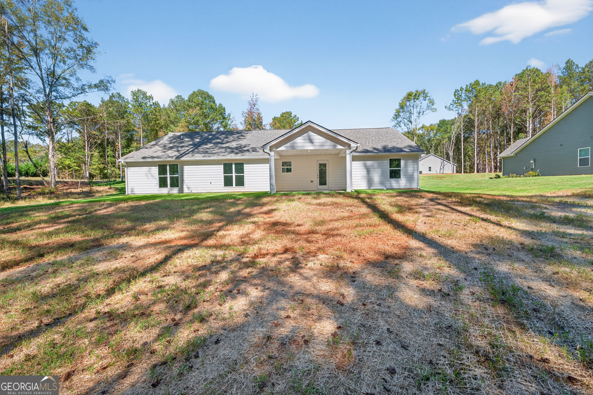 271 Mockingbird Lane, Unit 20 Winder, GA 30680 - Photo 36 of 38 a front view of a house with a yard and trees