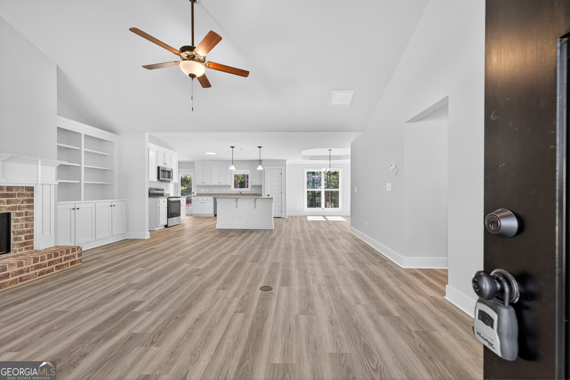 271 Mockingbird Lane, Unit 20 Winder, GA 30680 - Photo 4 of 38 a view of a room with wooden floor and a ceiling fan