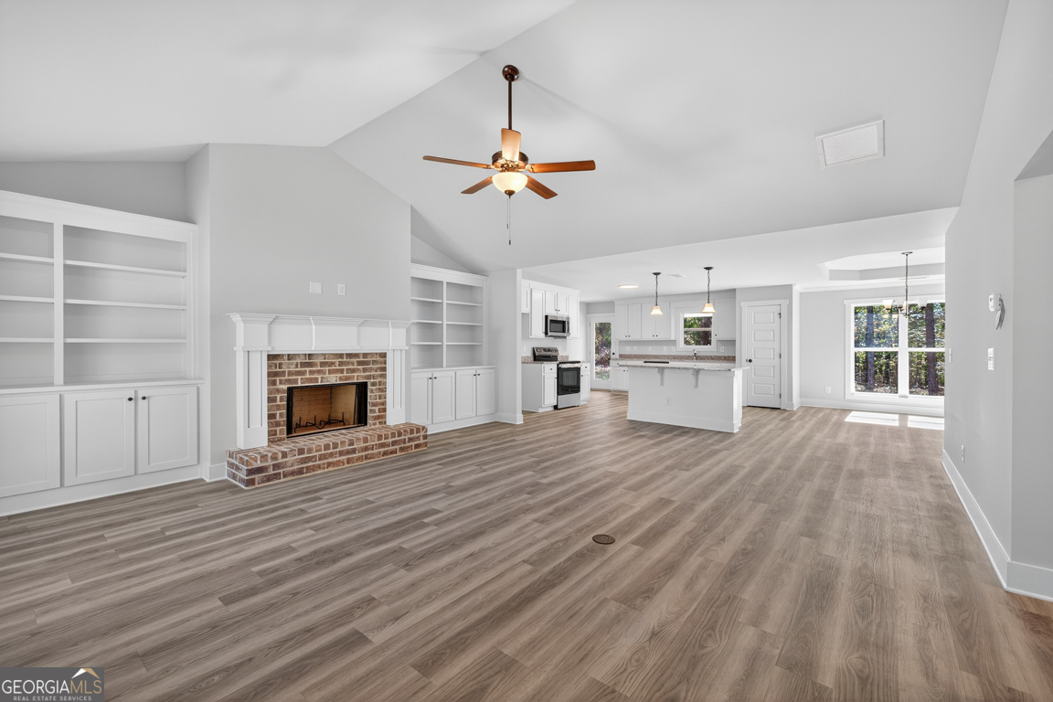 271 Mockingbird Lane, Unit 20 Winder, GA 30680 - Photo 5 of 38 a view of empty room with wooden floor and fireplace