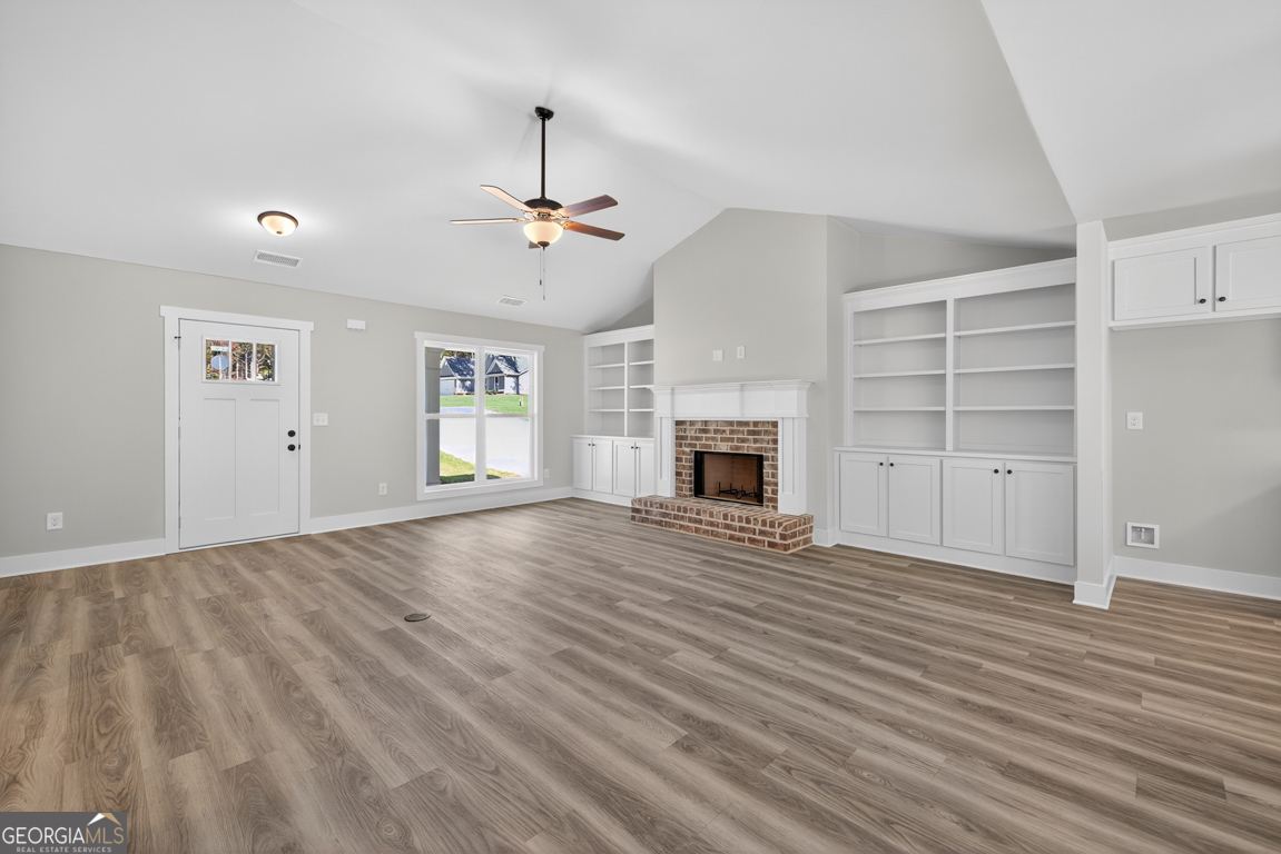 271 Mockingbird Lane, Unit 20 Winder, GA 30680 - Photo 7 of 38 an empty room with windows and fireplace