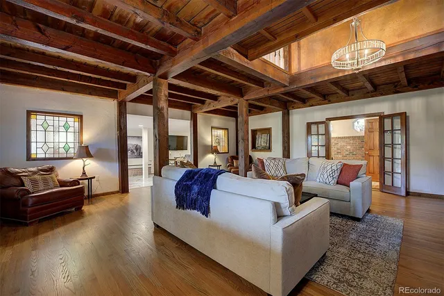 a kitchen with stainless steel appliances granite countertop a table chairs and wooden floors