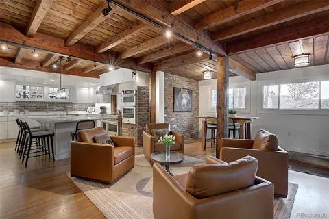 a living room with furniture a window and a table