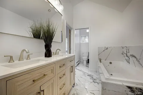 a living room with lots of furniture and a book shelf