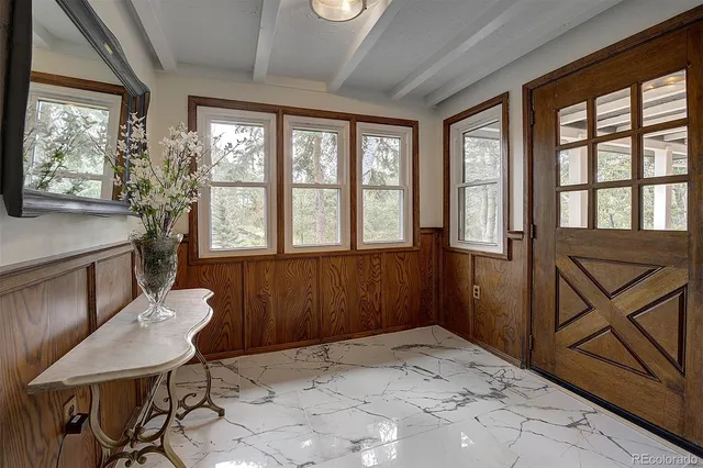 a view of a livingroom with wooden floor and furniture