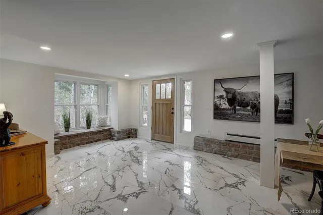 a view of a livingroom with furniture and a flat screen tv