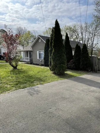 a view of kitchen with kitchen island a refrigerator a stove a sink dishwasher with wooden floor