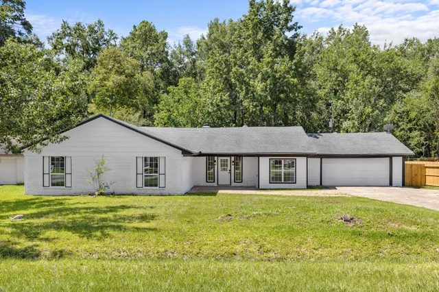 a front view of house with yard and green space