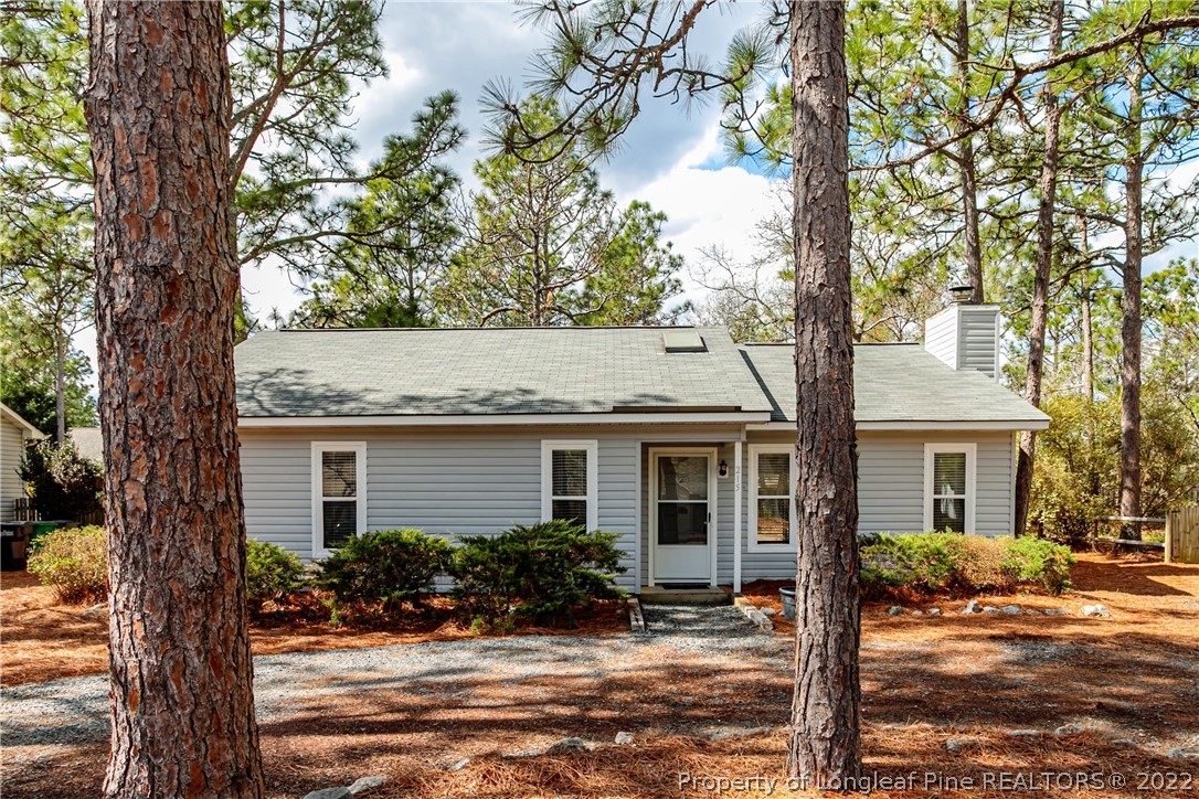 215 Fox Run Road Pinehurst, NC 28374 - Photo 1 of 24 a front view of house with yard and trees around