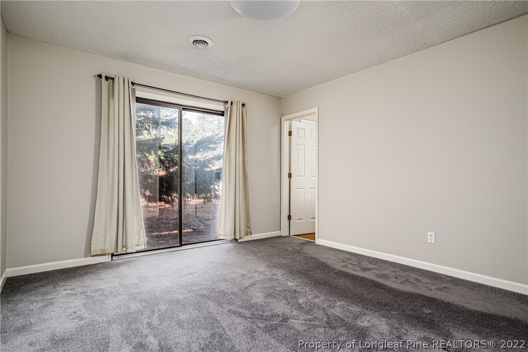 215 Fox Run Road Pinehurst, NC 28374 - Photo 13 of 24 a view of an empty room with a window