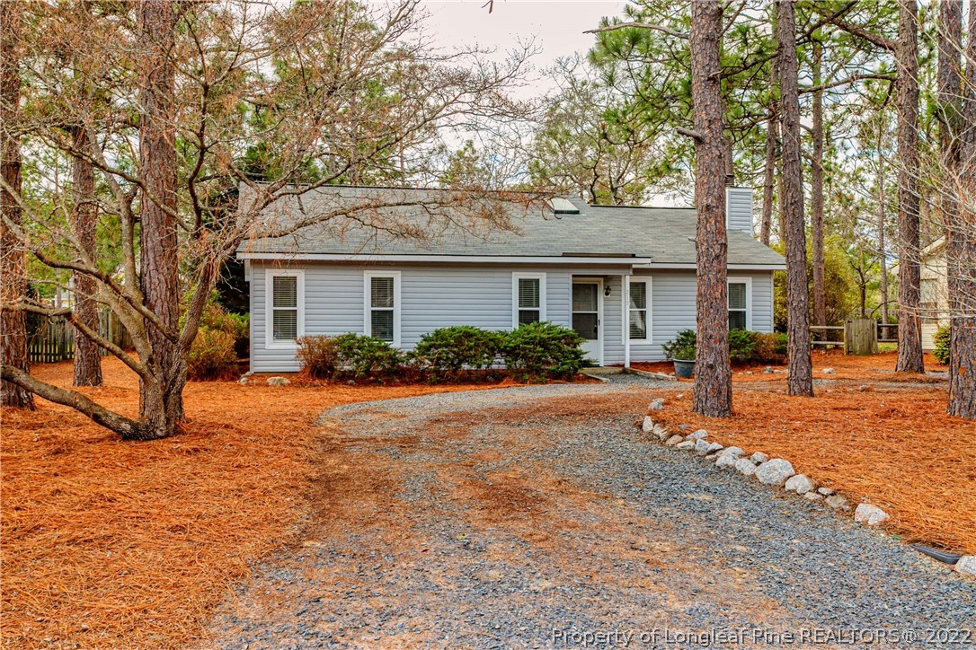 215 Fox Run Road Pinehurst, NC 28374 - Photo 3 of 24 a front view of a house with a yard and trees