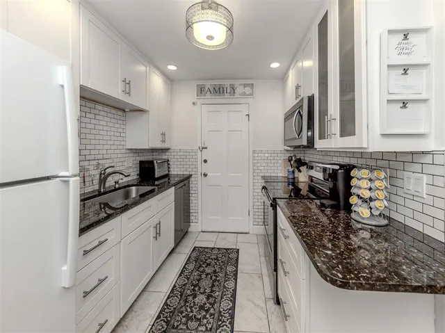 a kitchen with stainless steel appliances a stove microwave and cabinets