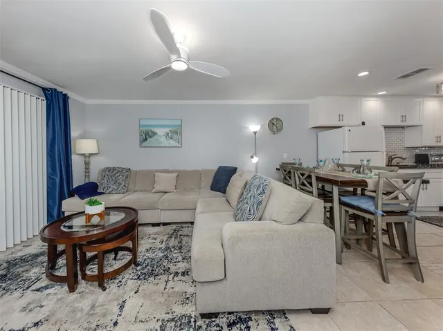 a kitchen with stainless steel appliances kitchen island granite countertop a table and chairs in it