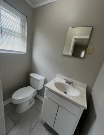 a white toilet sitting next to a bathroom sink
