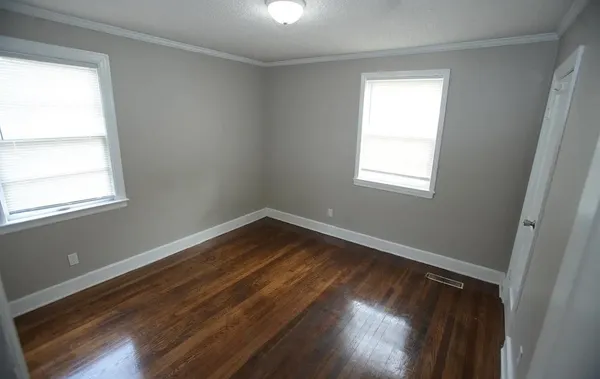 a view of small space with wooden floor and windows