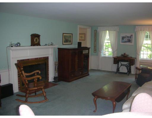33 Hoover Road Needham, MA 02494 - Photo 2 of 6 a living room with furniture and a fireplace