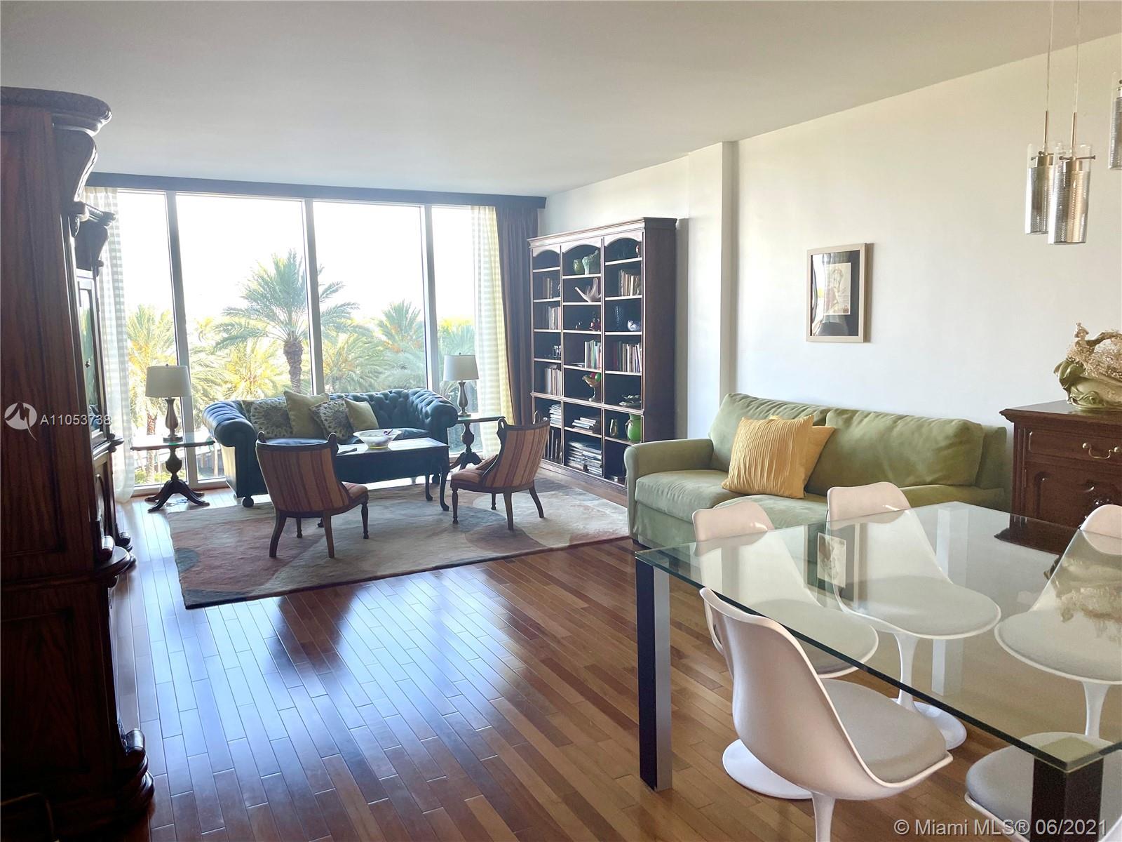10275 Collins Avenue, Unit 425 Bal Harbour, FL 33154 - Photo 1 of 18 a living room with furniture and a large window