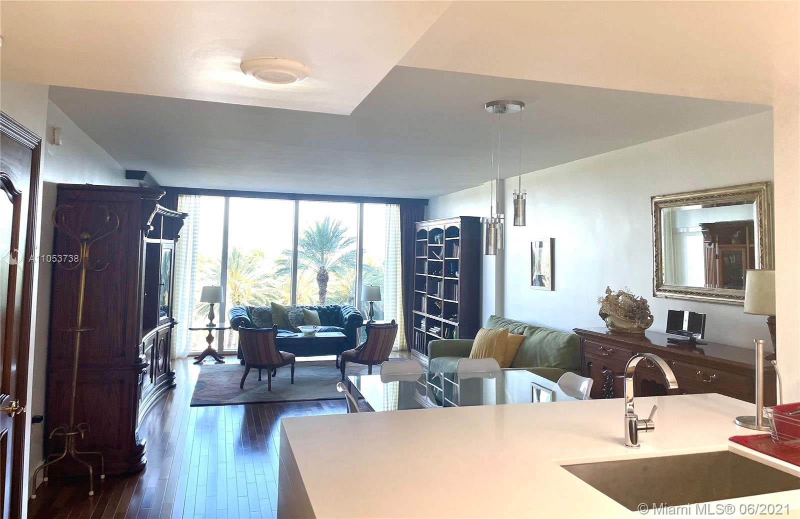 10275 Collins Avenue, Unit 425 Bal Harbour, FL 33154 - Photo 4 of 18 a living room with furniture large window and wooden floor