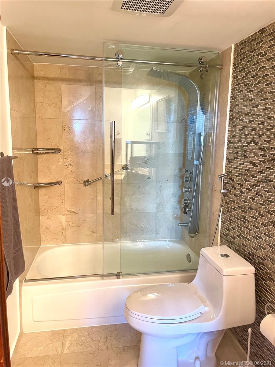10275 Collins Avenue, Unit 425 Bal Harbour, FL 33154 - Photo 6 of 18 a bathroom with a bathtub and a shower